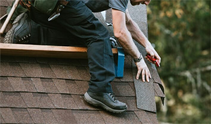 Specialist working on home roof