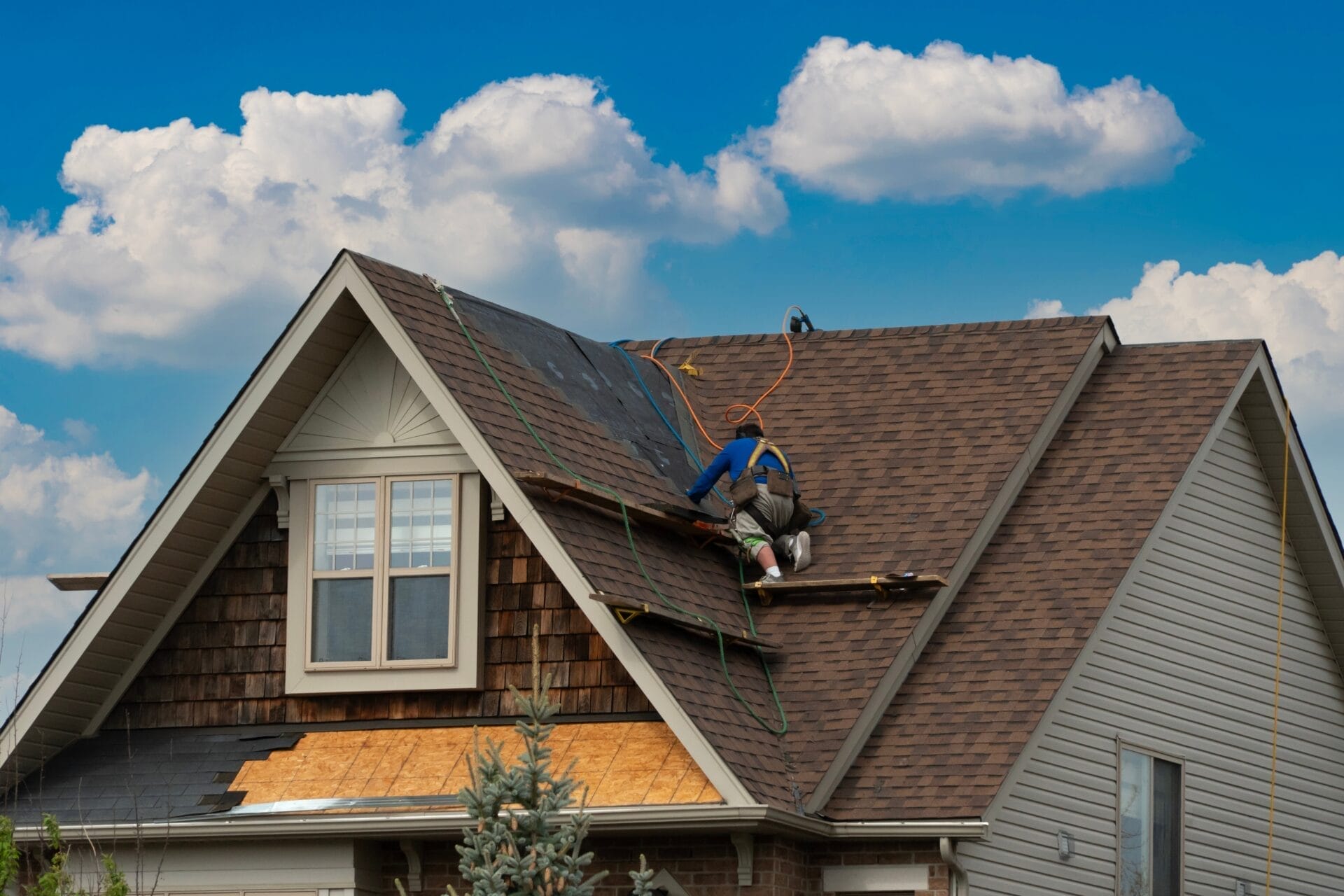 A,Worker Moves Along the roofing to the next Repair