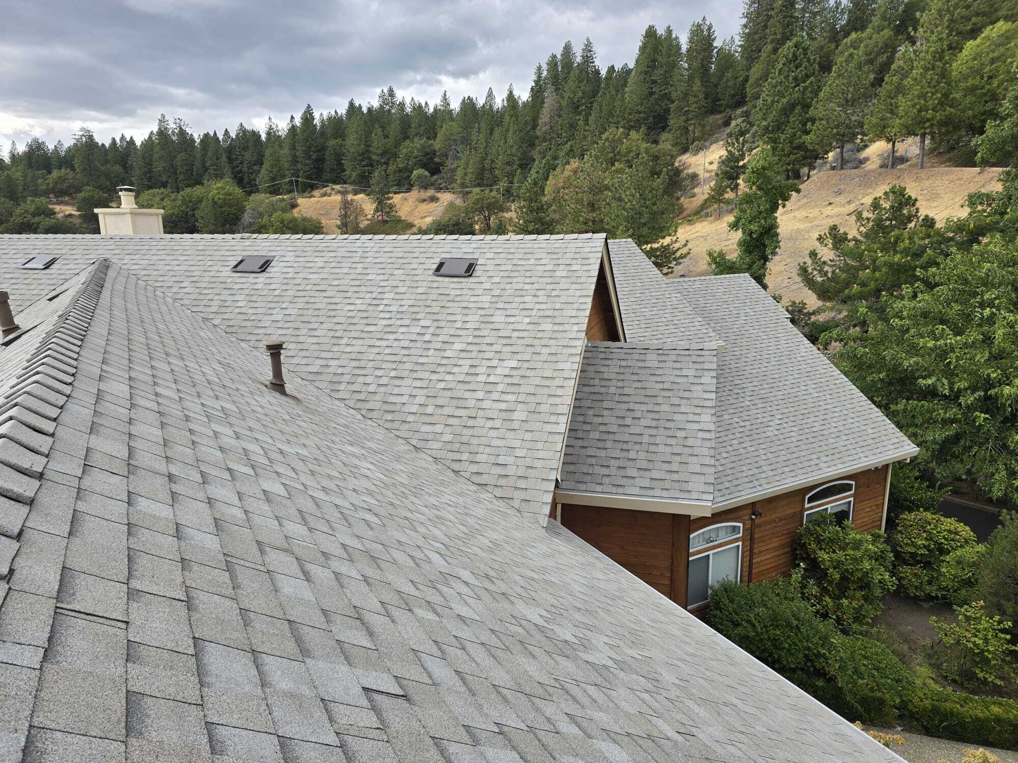Gutters with guards protecting a house in rugged natural environment