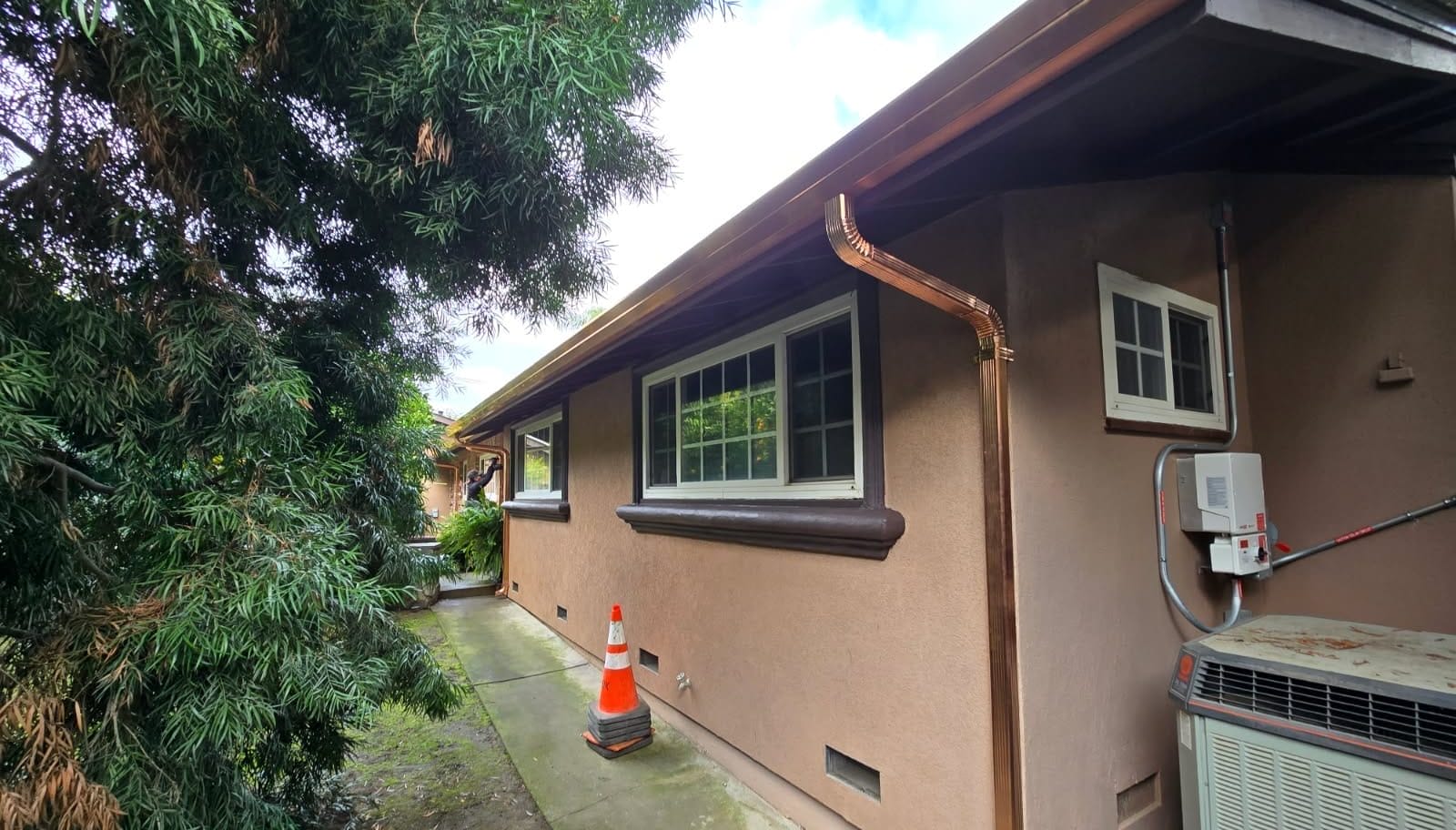 Gutter installation in El Dorado County featuring a newly installed custom copper gutter and downspout system on a residential home.